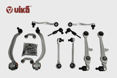 What are the components of a control arm assembly?
